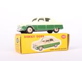a green and white toy car sitting on top of a box