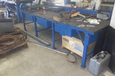a workbench with a lot of tools on it in a garage