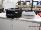 a printer sitting on top of a counter next to a printer