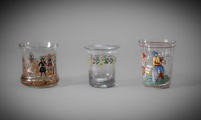 three different colored glass vases sitting next to each other on a table