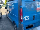 a blue van parked in a parking lot next to other cars