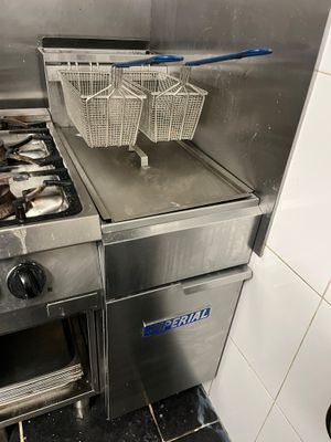 two baskets of fish sitting on the stove in the kitchen