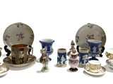 many different types of tea cups and saucers on the table