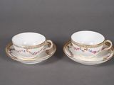 pair of porcelain cups and saucers with gold trims