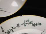two plates with green and white designs on them