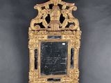 a mirror hanging on the wall with a bird on it