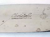 a close up of a knife with writing on it