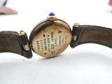 a close up of a watch on a white surface