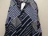 a blue and white shirt hanging on a hanger on a wall