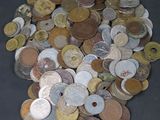 a pile of coins sitting on a table with a black background