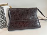 two purses are sitting next to each other on a table