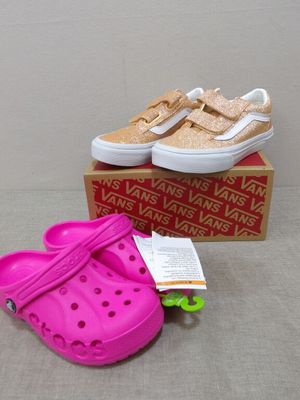 a pair of pink shoes and a pink shoe on a box