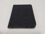 a black tablet computer sitting on a white table