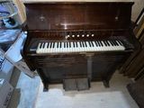 a piano that is sitting in the corner of a room