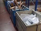 a large metal container sitting in the middle of a warehouse filled with pallets