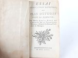 an old book that is open on a white surface