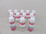 several bottles of hand sanitizer are lined up on a table