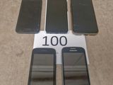 several cell phones are sitting on a table with a price tag