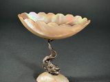 a silver and mother of pearl bowl with a snake on it