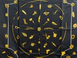 an image of a black and yellow scarf with gold designs