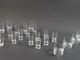 many glasses and a bottle of water on the table
