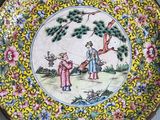 two plates with a painting of a man and a woman on them