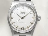 a watch that is sitting on a white surface