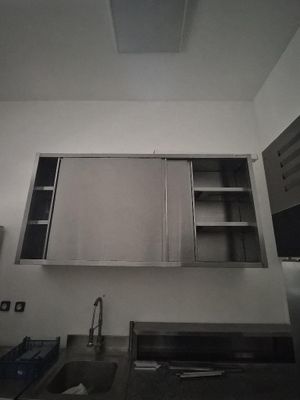 a kitchen with a sink and cabinets in it