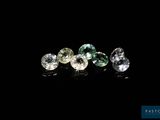 a group of three different colored diamonds on a black surface