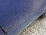 a close up of a blue car with a black rim