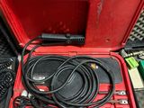 a red tool box with wires and other tools in it
