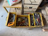 many different tools in a box on the floor