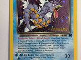 a close up of a pokemon card hanging on a wall