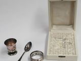 a small box with a spoon, a spoon and a spoon rest next to it
