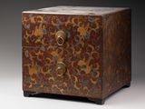 a small wooden chest with a floral design on it
