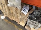 a large pile of boxes on the ground next to a truck