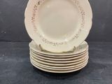 six white plates stacked on top of each other on a table