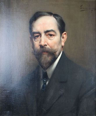 portrait d'un homme barbu et moustachu, vêtu d'un costume noir