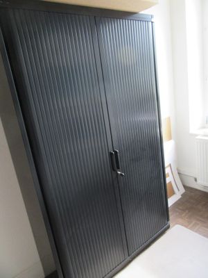 an image of a black cabinet in a bedroom