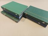three green books stacked on top of each other on a table
