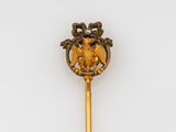 a gold colored stick with a bird on it