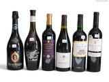 several bottles of wine are lined up on a white surface