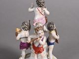 a figurine of a group of people on a pedestal
