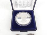 an image of a silver coin and a silver coin in a blue box