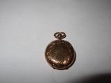 a small gold locke with a picture on it
