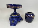 a blue vase and a blue vase sitting next to each other
