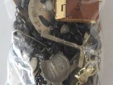 a bag full of assorted buttons and chains