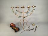 a gold menorat with candles and a toy truck
