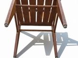 a wooden chair that is sitting on a white surface