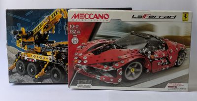 two boxed legos of a red sports car and a yellow truck